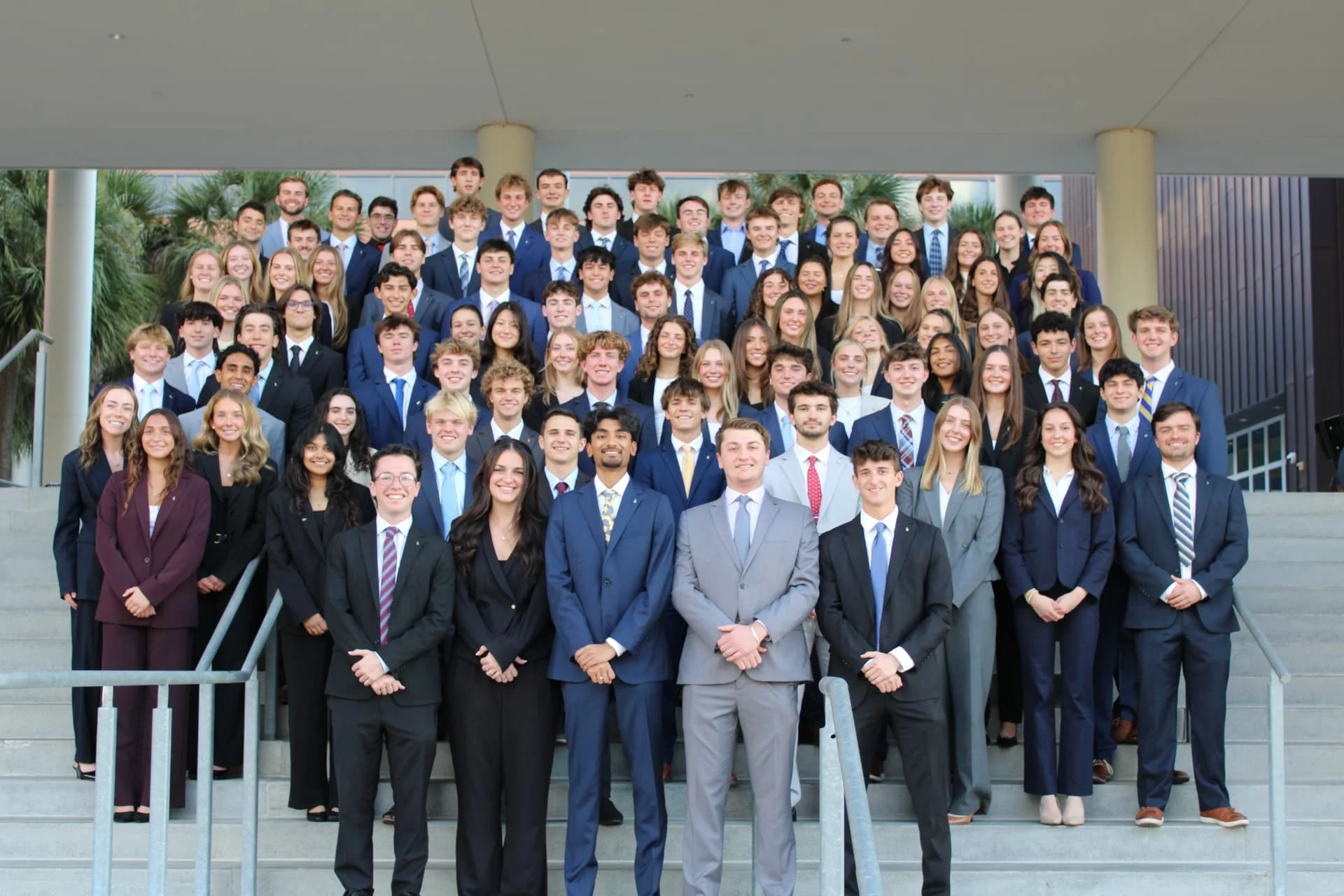 Alpha Kappa Psi Beta Upsilon chapter photo on the steps in business professional attire